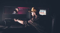 a man in a hat is recording a song in a recording studio