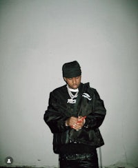 a man in a black jacket holding a cell phone